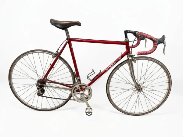 A complete side profile view of a preserved 1970s metallic bordeaux Viner Special Professional road bicycle with Campagnolo Nuovo Record groupset on a plain white background.